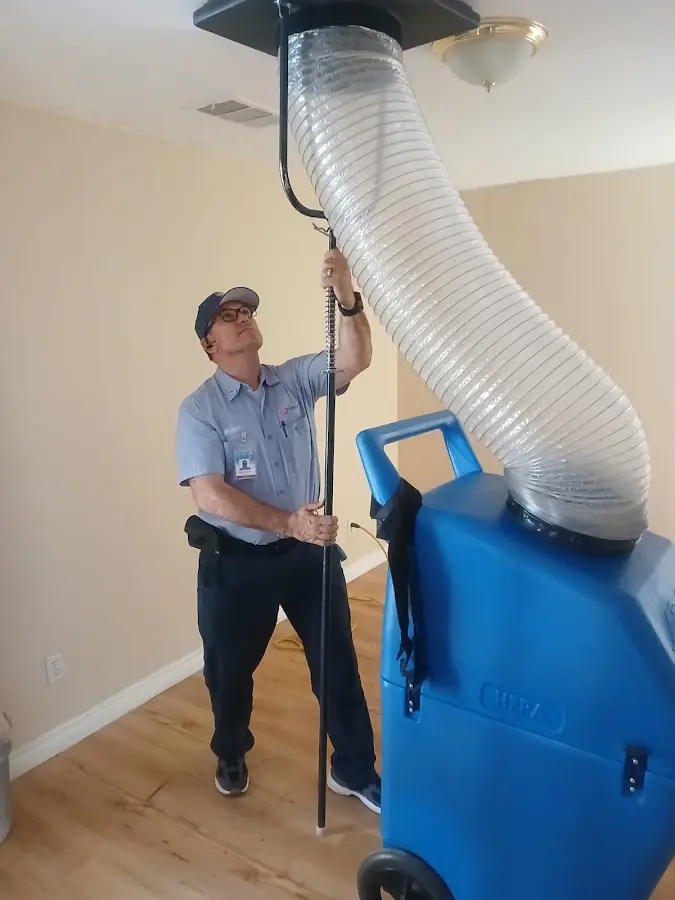 Furnace Tune-Up technician using HEPA equipment in Princeton